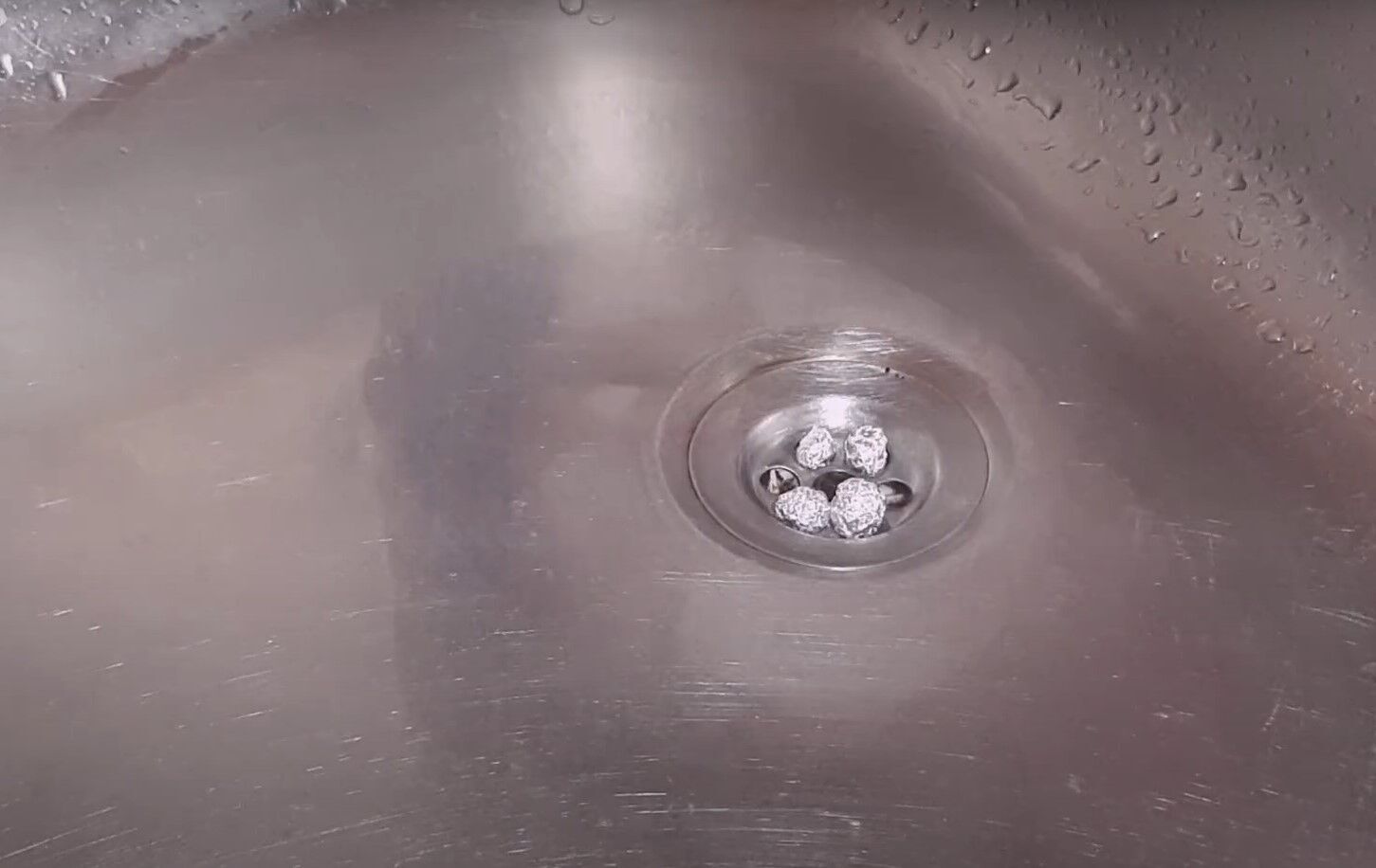 Зачем хозяйки кладут в слив раковины на кухне три шарика из фольги – как почистить слив на кухне