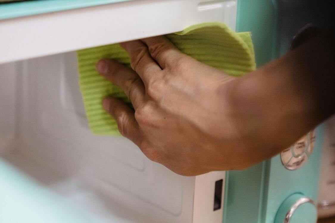 Wet towel and cup: quality ways to clean your microwave quickly