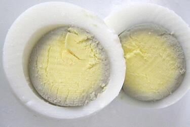 Why does the yolk darken and turn green while cooking eggs and how to avoid it