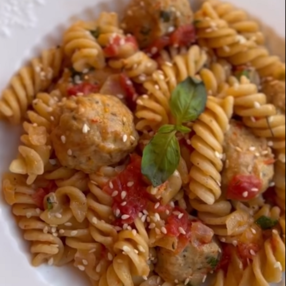 Chicken meatballs in tomato and sour cream sauce with pasta