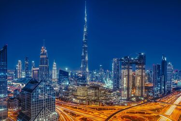 Dubai night landscape with skyscrapers and lighted roads